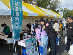 本学ブース全体が写っており、受付に人が並んでいる様子